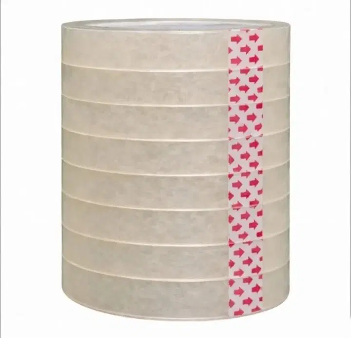 Stack of transparent adhesive packing tape rolls with red arrow seal strip