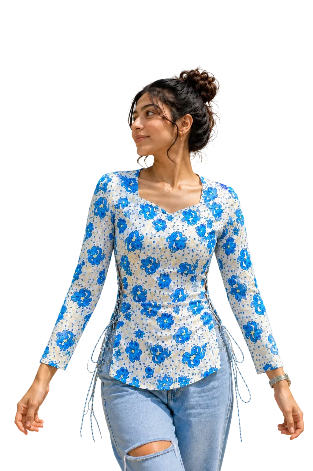 Woman wearing a white long sleeve top with blue floral print and side tie-up details