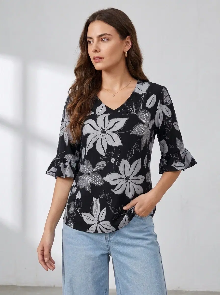 Women's black V-neck top with white floral print and flared three-quarter sleeves