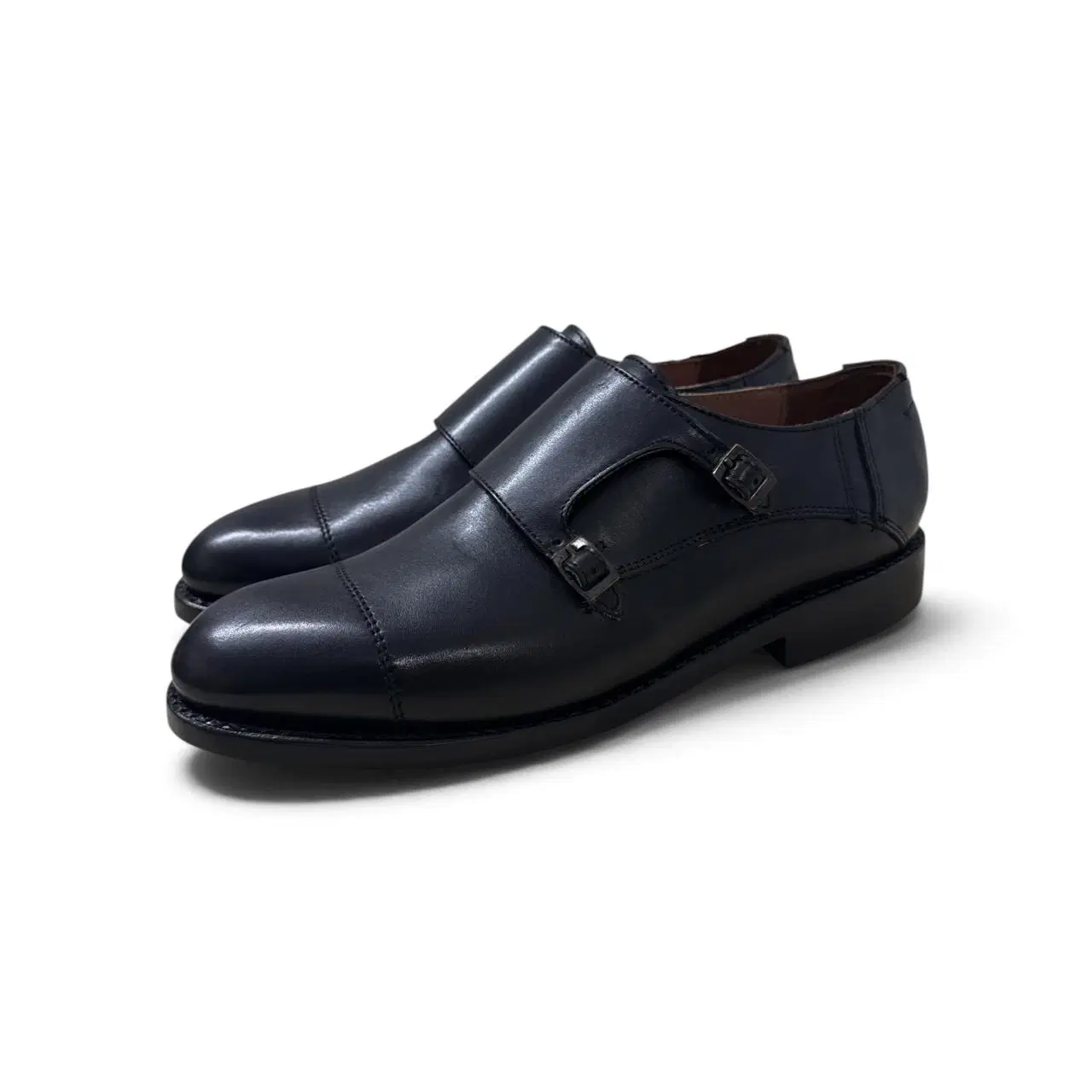 Pair of black leather double monk strap formal shoes with cap toe and low heel
