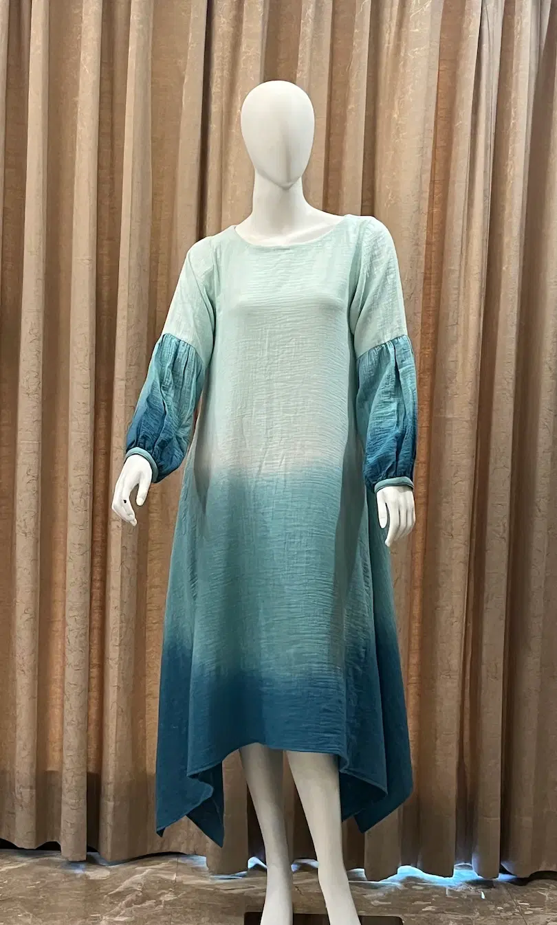 Women’s blue ombre high-low midi dress with puff sleeves displayed on a mannequin