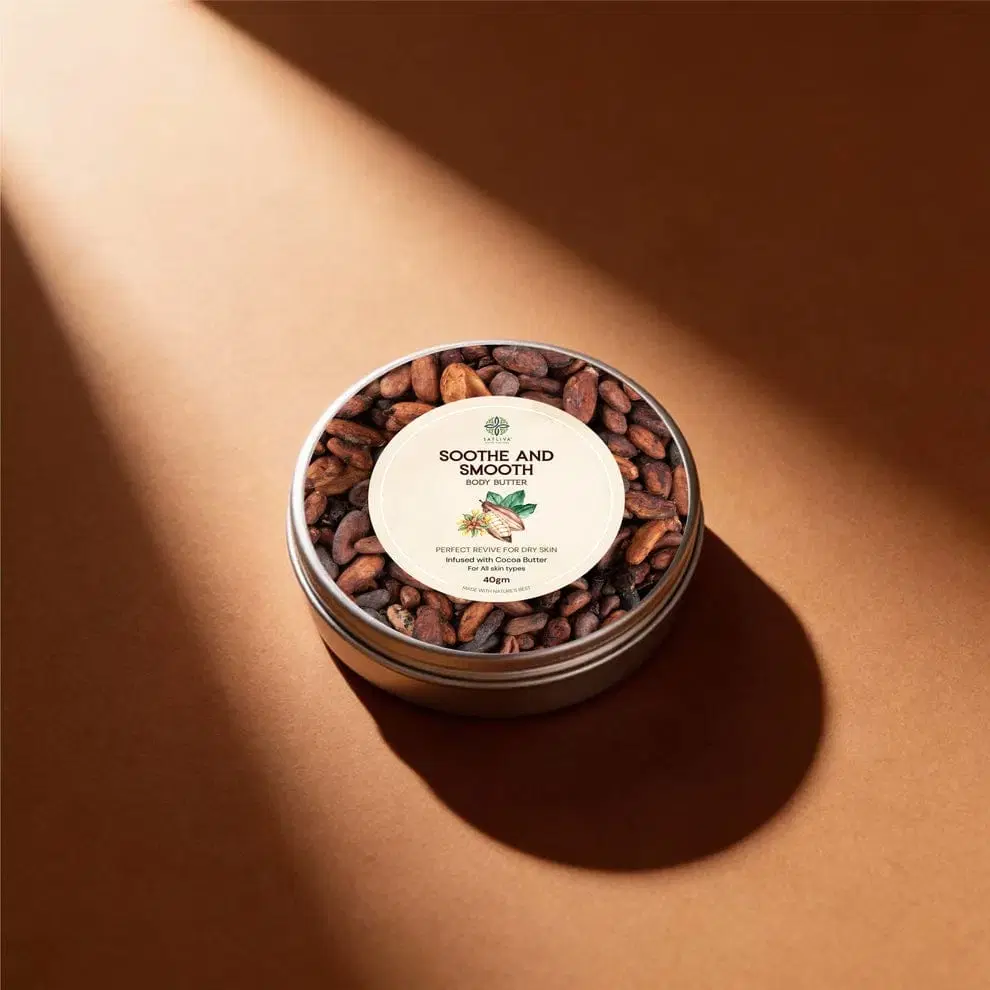 Satliva Soothe and Smooth body butter tin with cocoa beans around the lid on a warm brown background