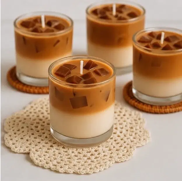 Four layered iced coffee style candles in clear glass jars with cube details and white wicks