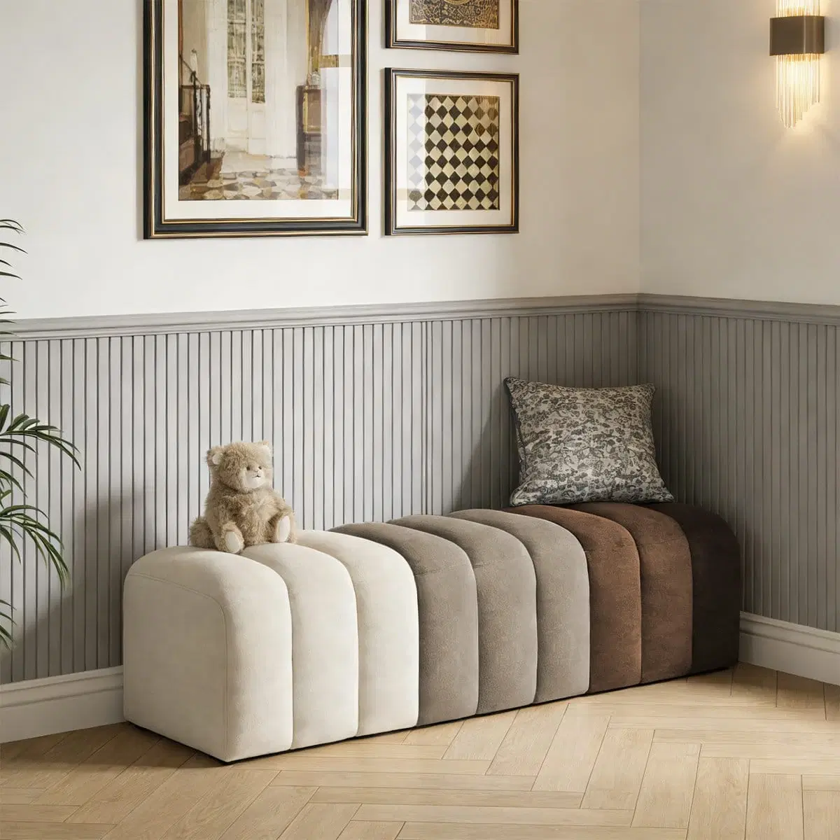 Color-block upholstered bench ottoman in a corner setup with a teddy toy and cushion on top