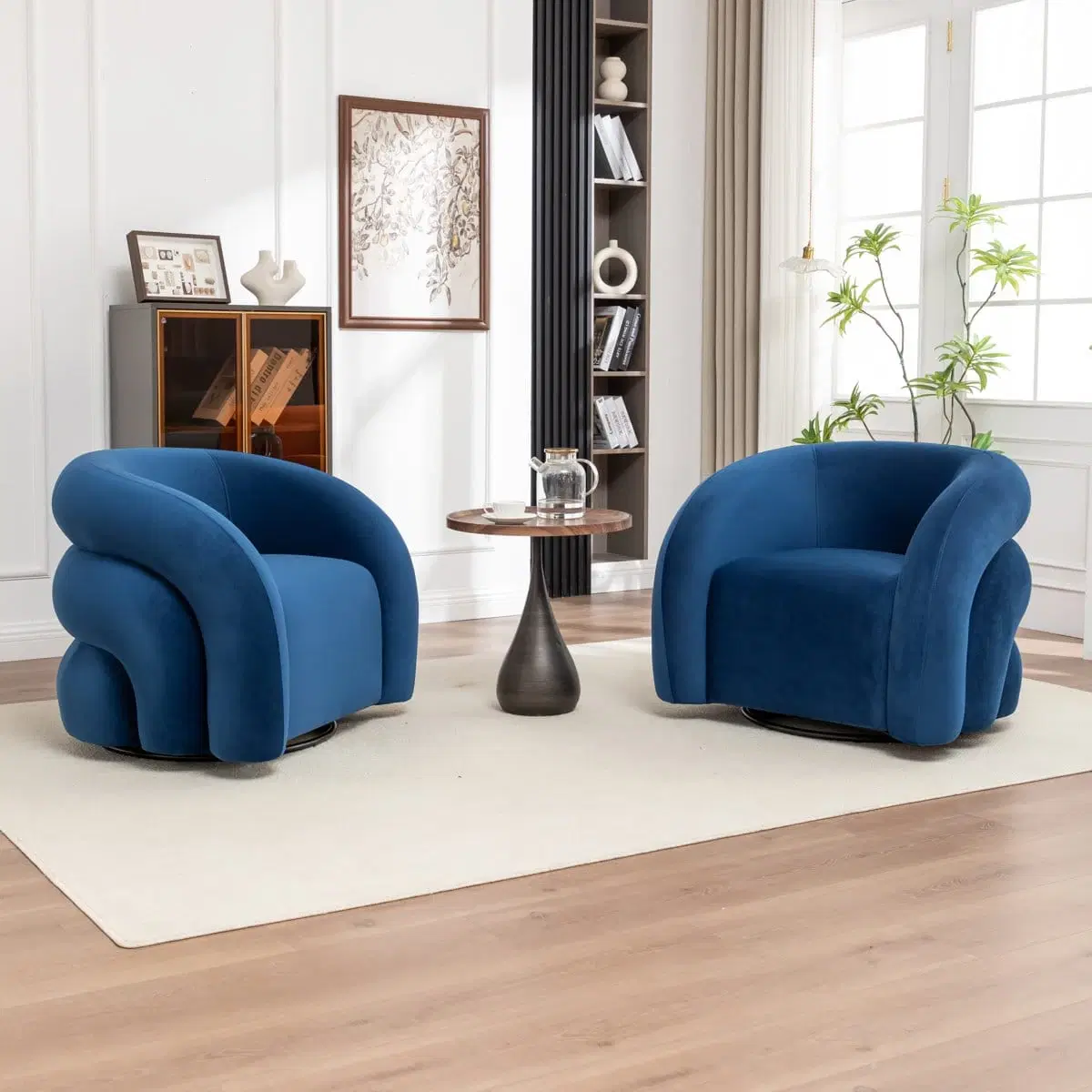 Front angled view of a blue velvet barrel armchair with rounded arms and a black swivel base