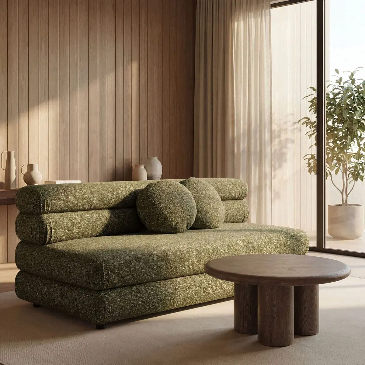 Front angled view of olive bouclé armless sofa with rolled back cushions and two round pillows