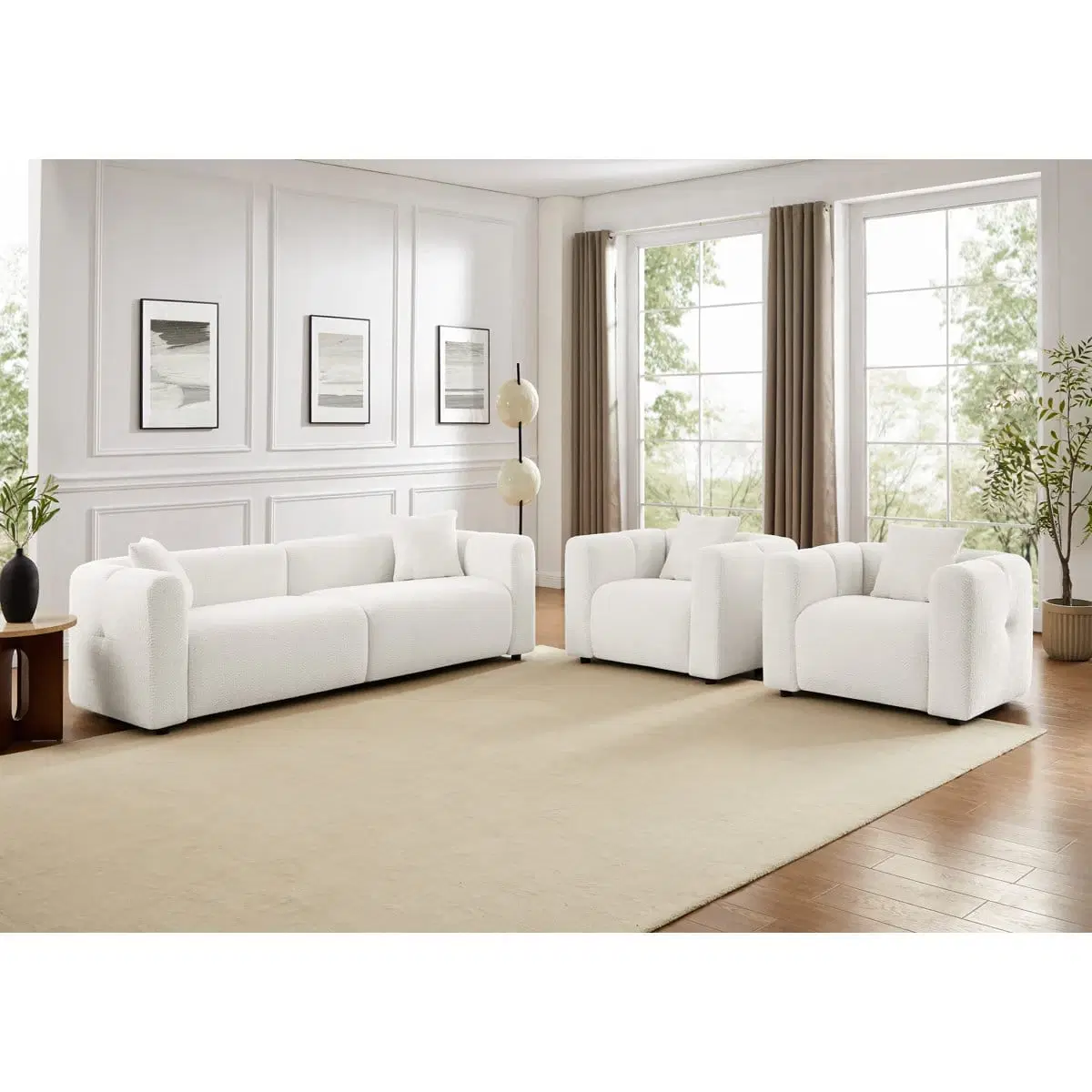 Front angled view of white boucle 3-seater sofa with two matching armchairs in a bright living room