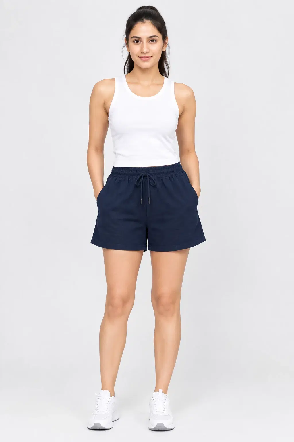 Front view of navy blue drawstring shorts with elastic waist and side pockets, styled on a model