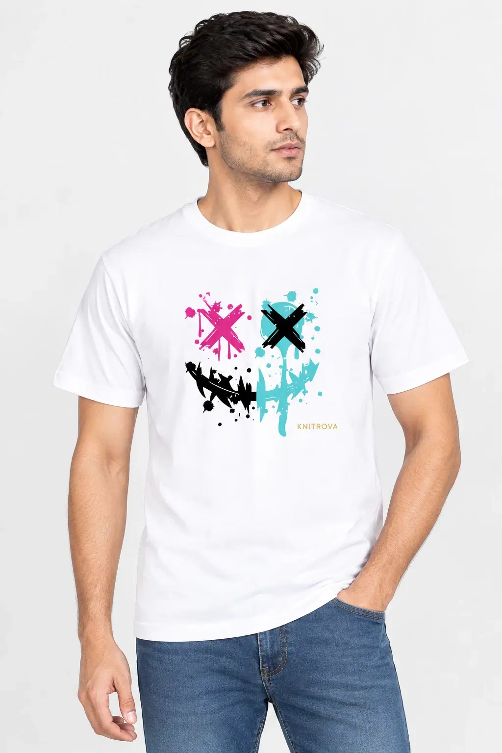 Men's white crew neck T-shirt with abstract pink, blue and black chest graphic, worn with blue jeans