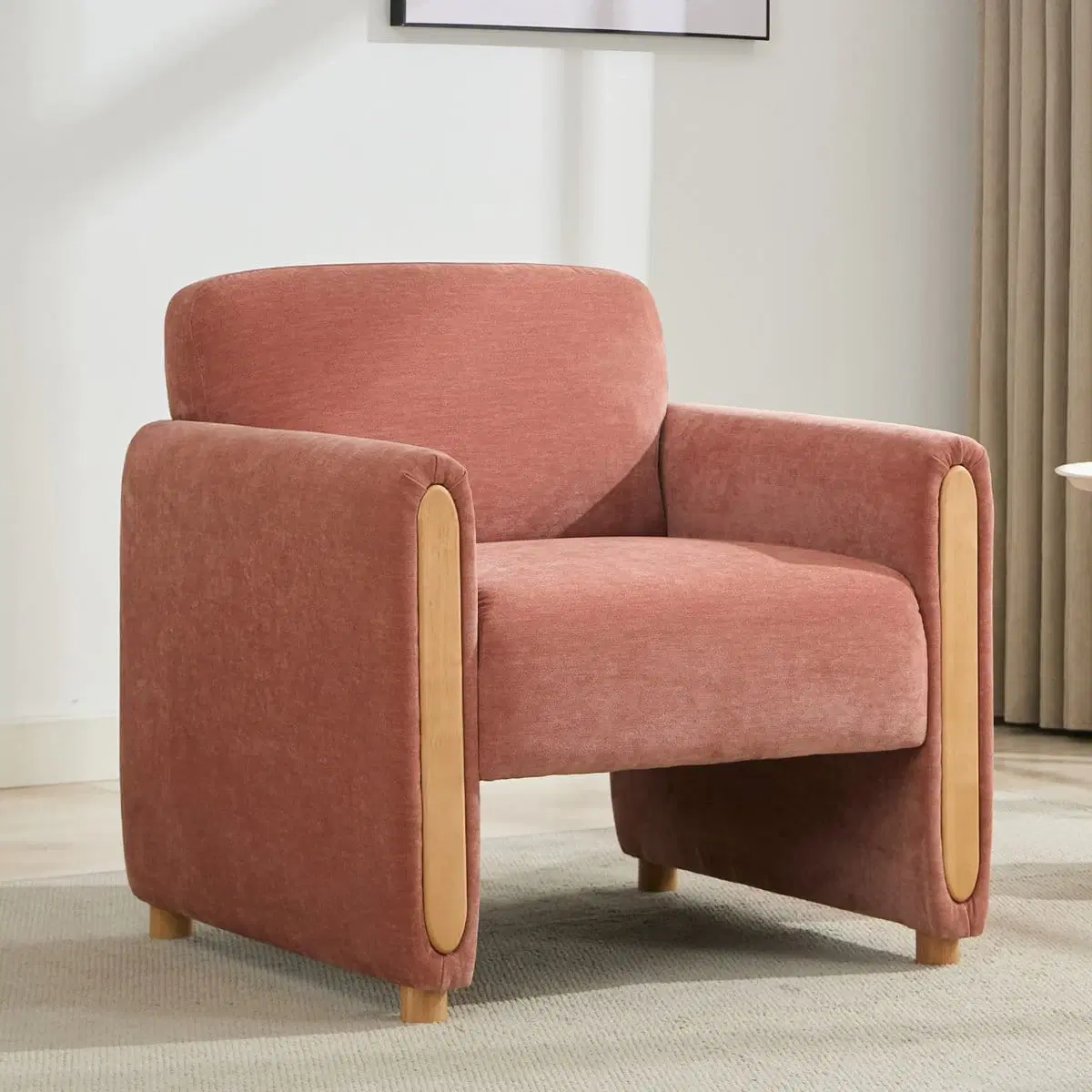 Front three-quarter view of pink chenille accent chair with rounded back and wood-look arm panels