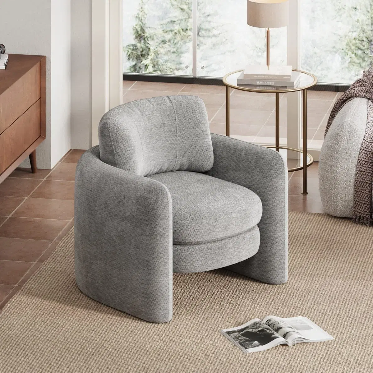 Light grey upholstered accent chair styled in a living room, angled front-left on a beige rug