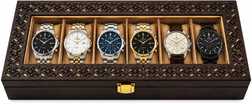 Front view of brown carved-pattern watch box with glass lid, gold latch, and six cushioned watch slots