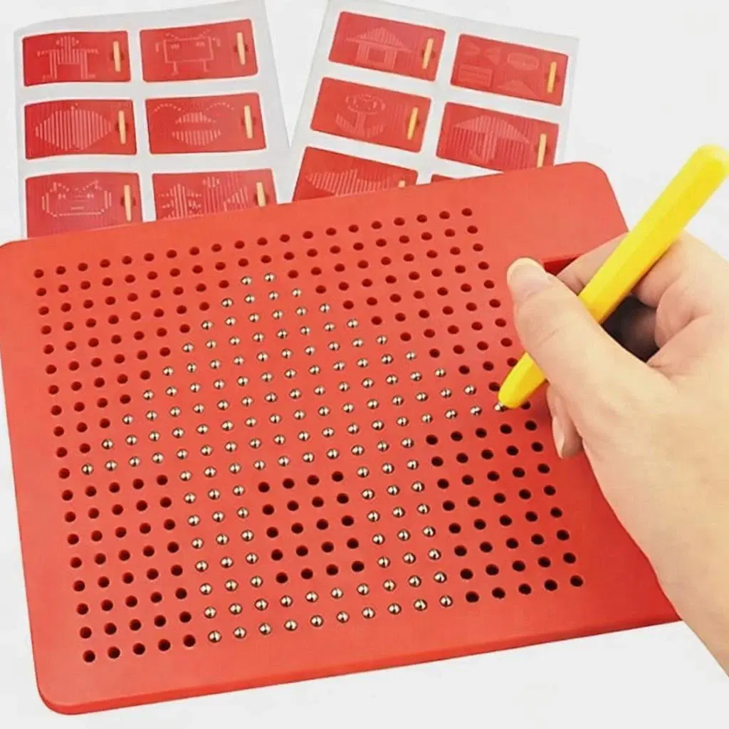 Red magnetic dot drawing board with yellow stylus in hand and pattern cards displayed in the background