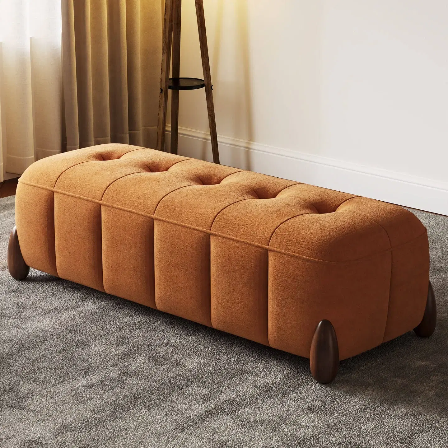 Camel brown tufted bench ottoman with rounded wooden legs shown at an angled front view
