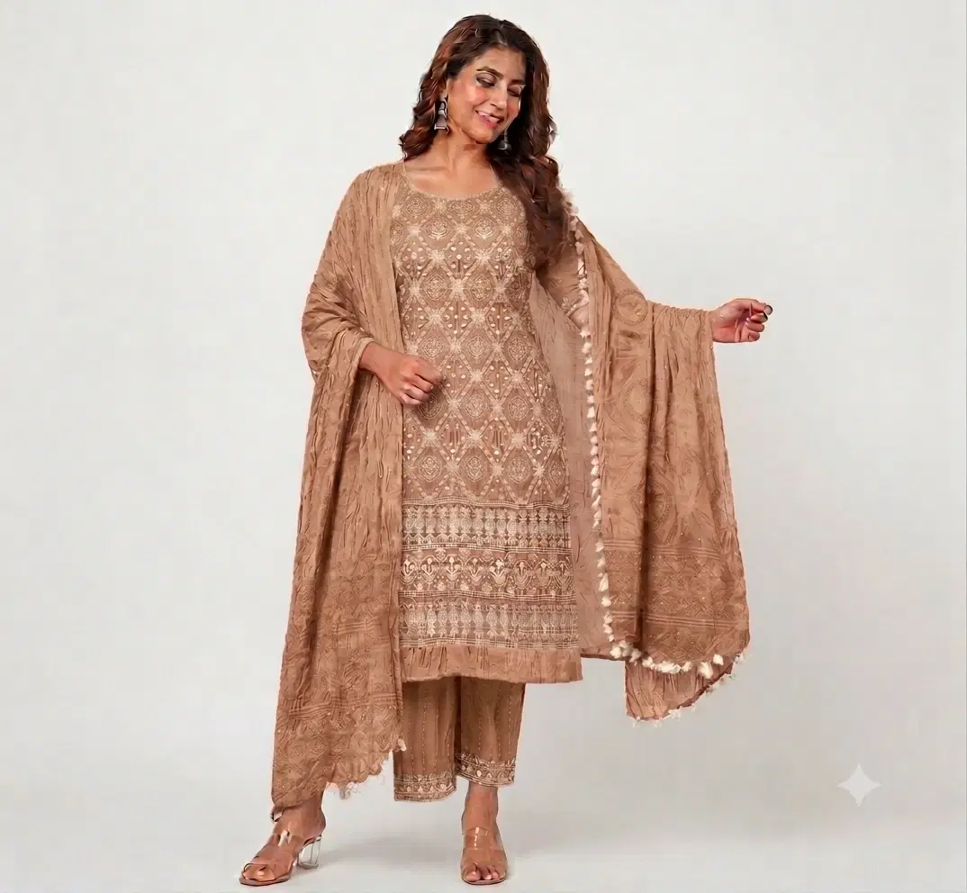 Model wearing a beige embroidered kurta set with palazzo pants and wide tassel dupatta