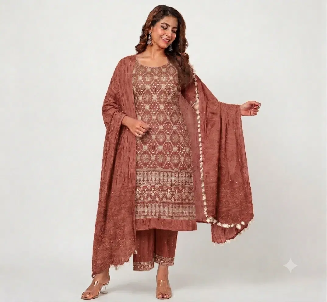 Woman wearing rust embroidered kurta set with matching palazzo and tassel dupatta, full front view