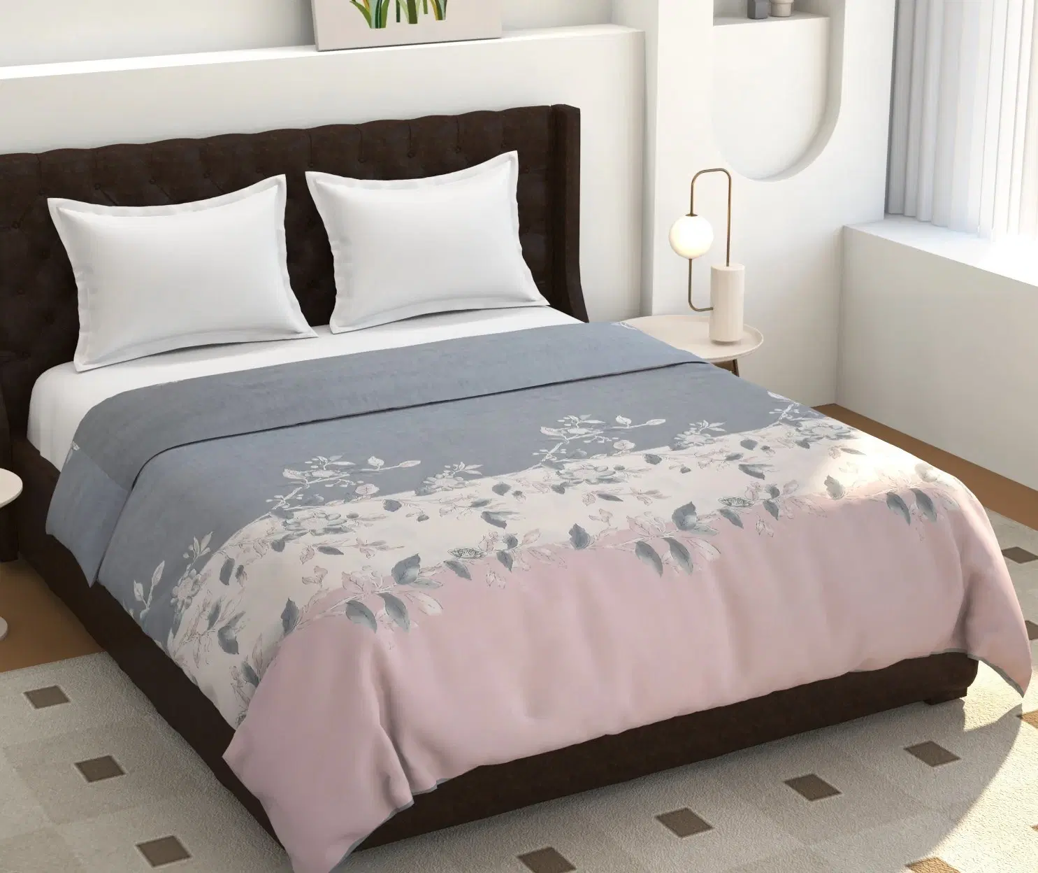Grey and blush pink floral comforter spread on a double bed with white pillows in a styled bedroom