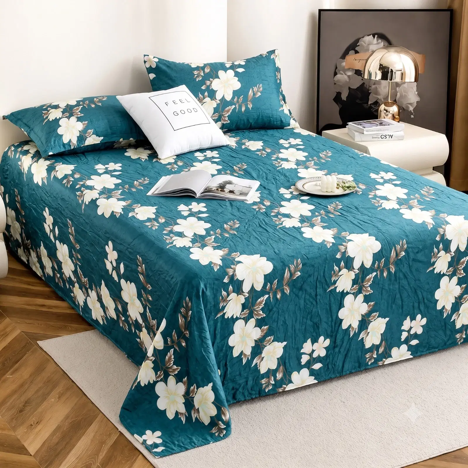 Angled view of teal floral bed sheet spread over a bed with matching pillow covers and white flower print