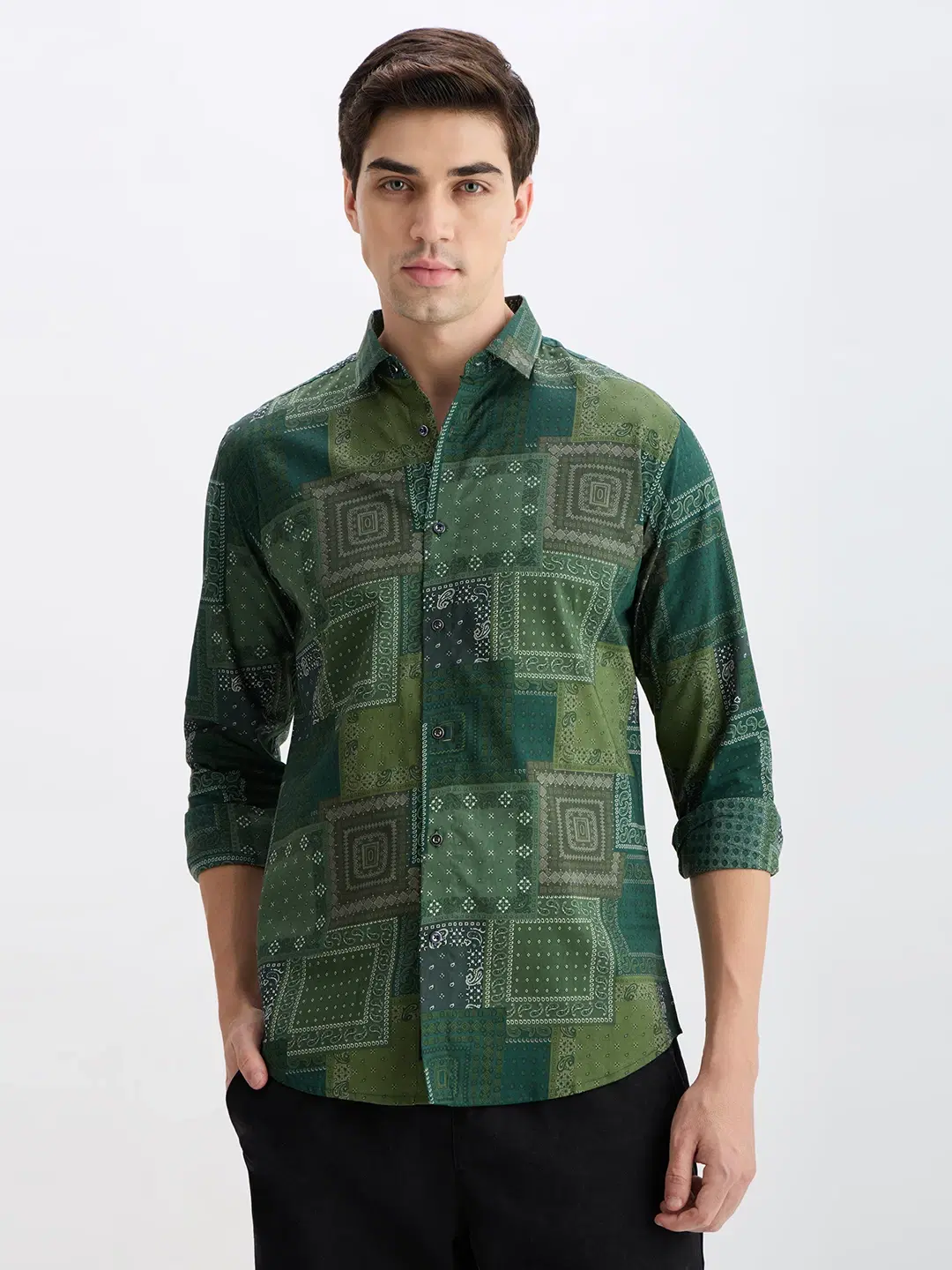 Front view of green printed casual shirt with patchwork bandana-style pattern and rolled sleeves