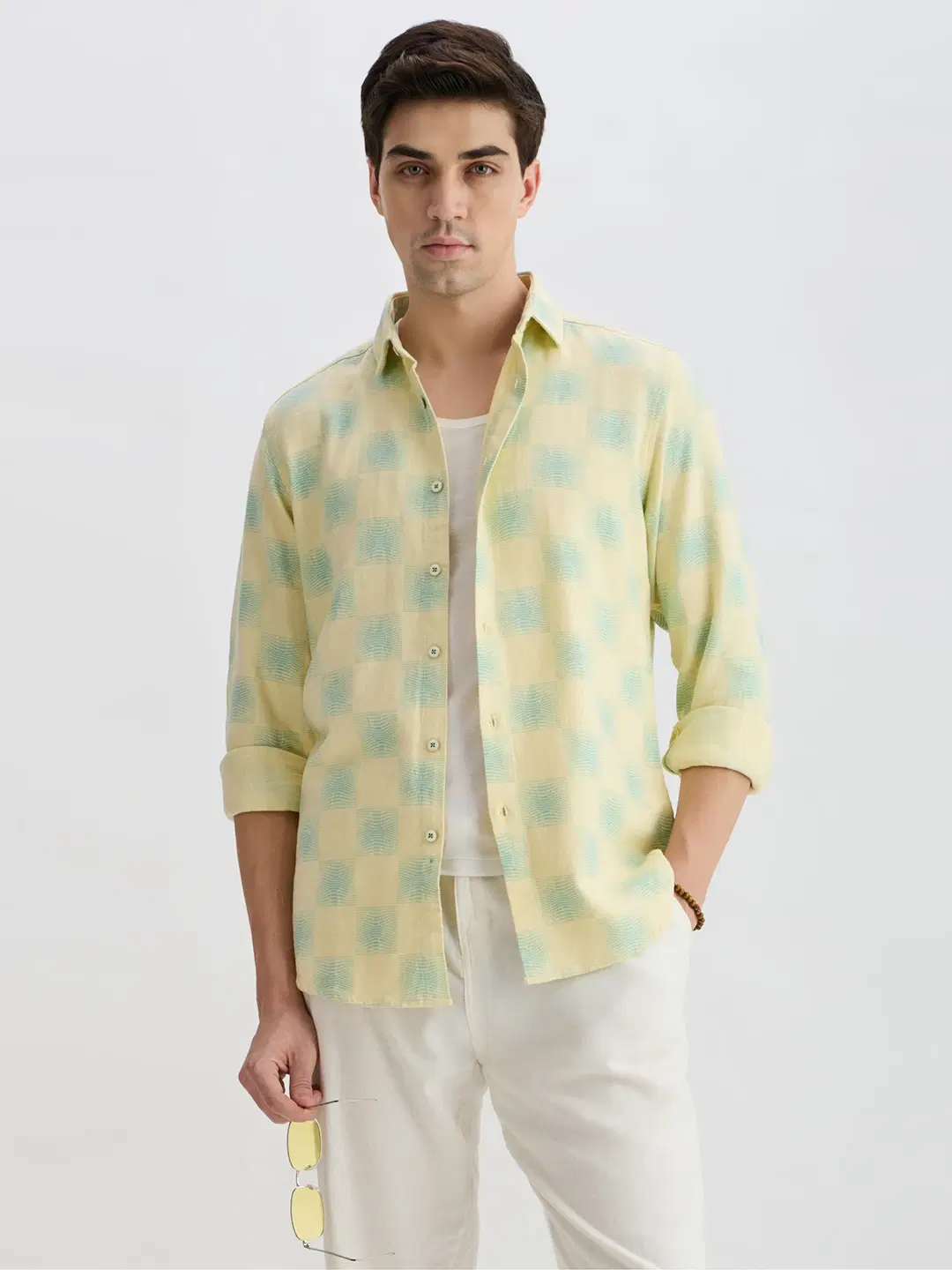 Mid-length styled view of the open shirt with rolled cuffs and pastel checks