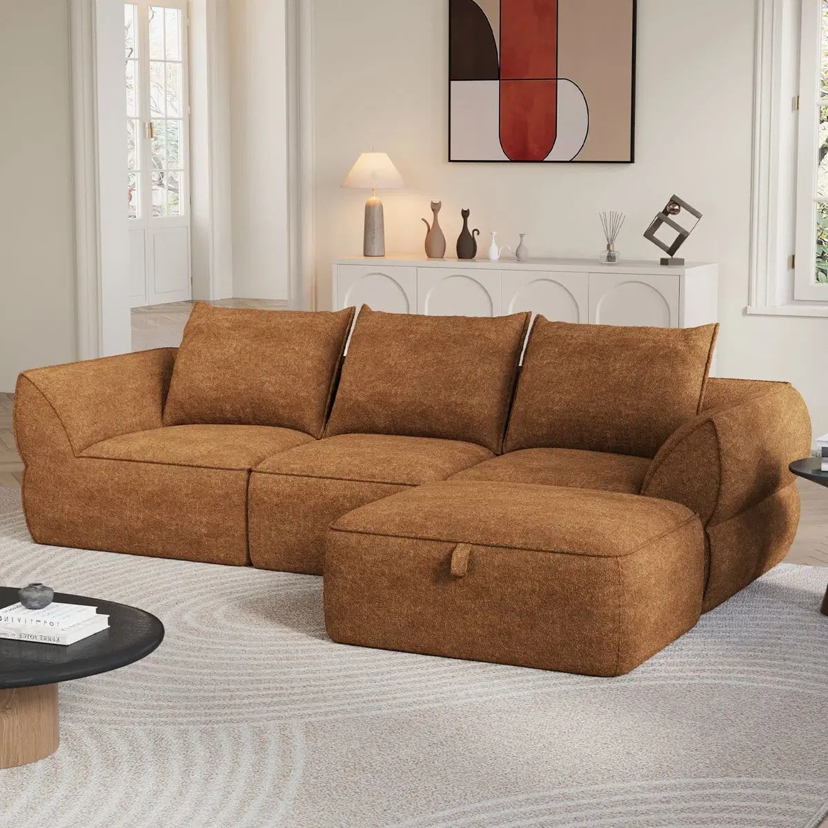 Front angled view of orange boucle modular sofa with right-side ottoman in a styled living room