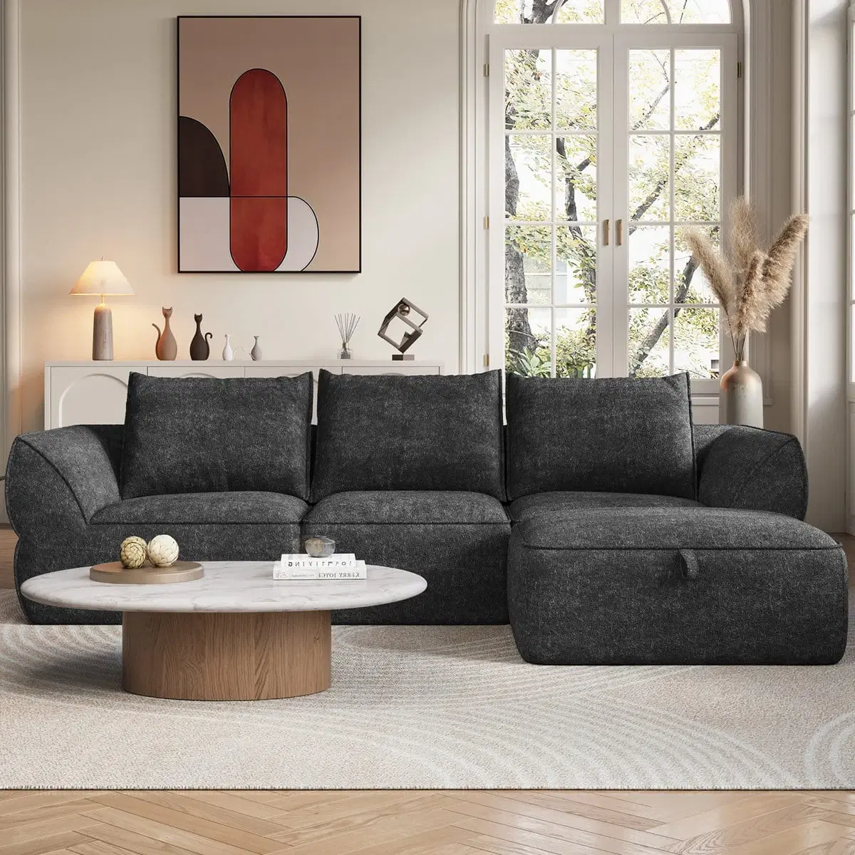 Front view of dark grey modular 3-seater sofa with right-side ottoman in a styled living room