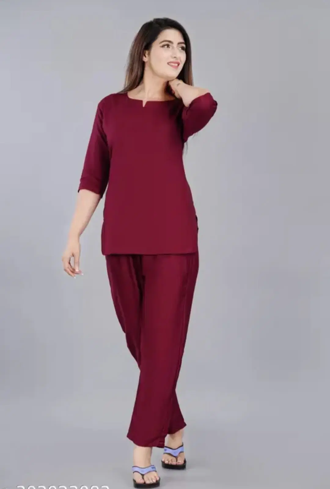 Woman modeling a maroon lounge co-ord set with 3/4 sleeve top and matching straight pants