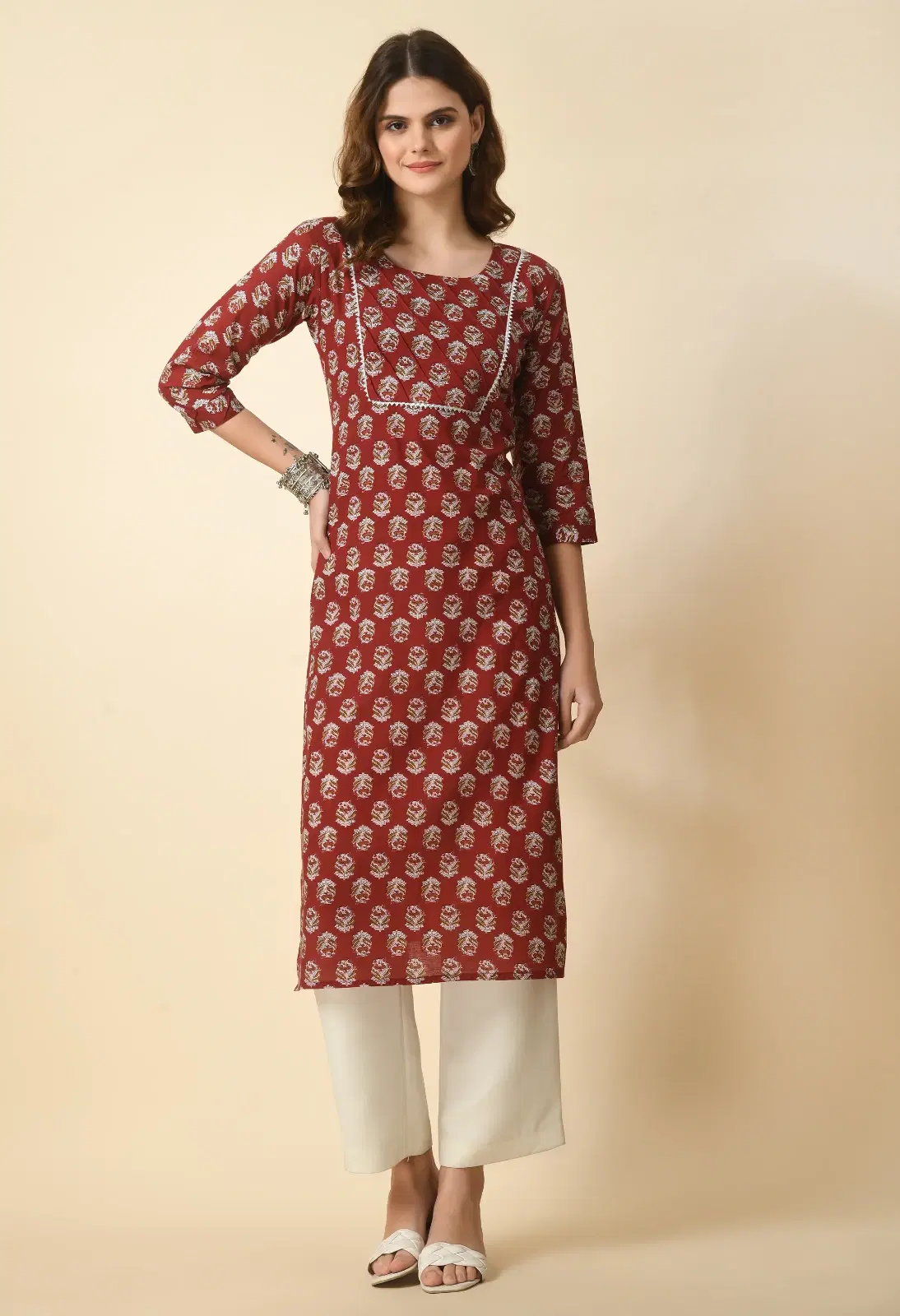 Front view of rust printed straight kurta with round neck, contrast piping and three-quarter sleeves