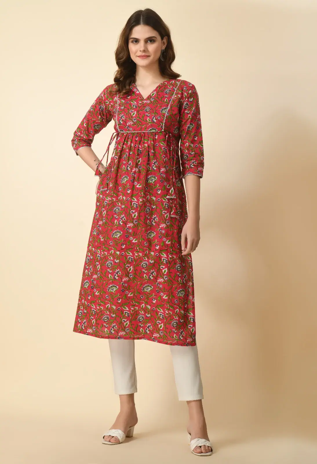 Front full-length view of a red floral printed kurta with V-neck, tie detail and three-quarter sleeves