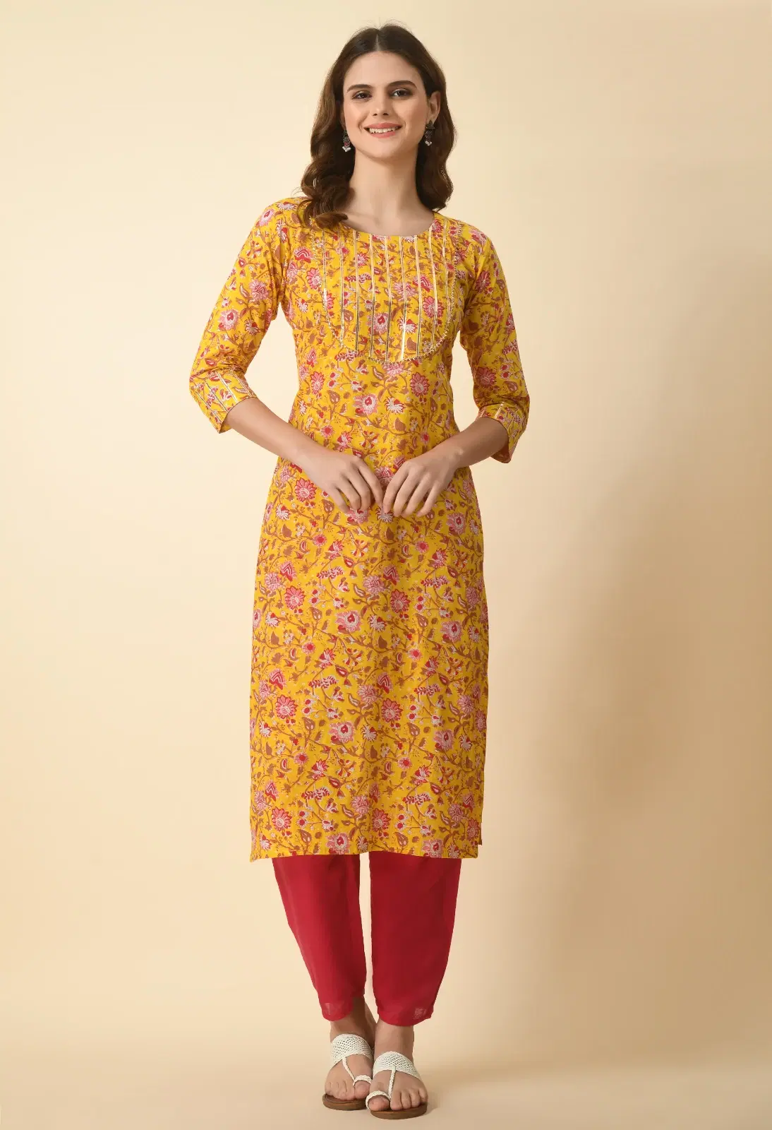 Front full-length view of mustard floral regular kurta with pintuck yoke and three-quarter sleeves