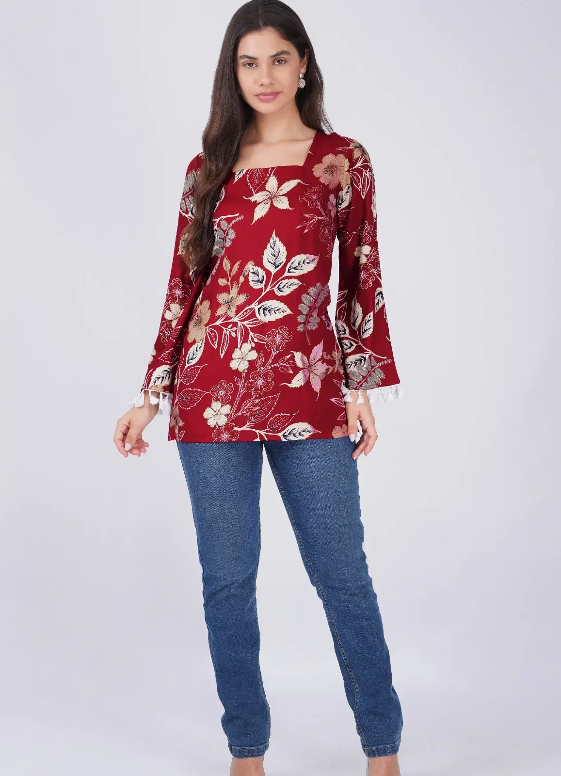 Full front view of maroon floral top with square neckline and tassel-trim bell sleeves