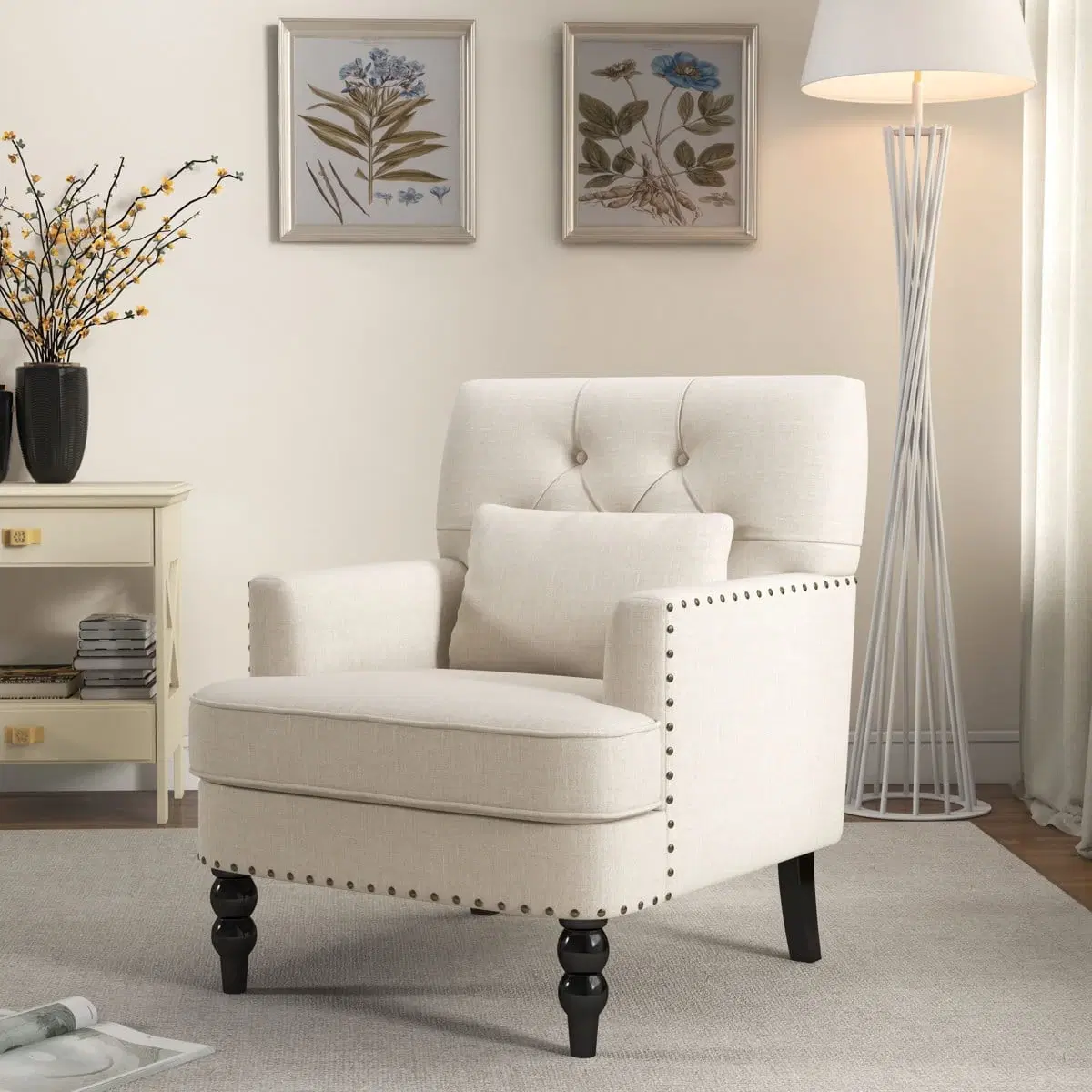 Cream upholstered accent chair with tufted back, nailhead arms, black wood legs and matching lumbar pillow