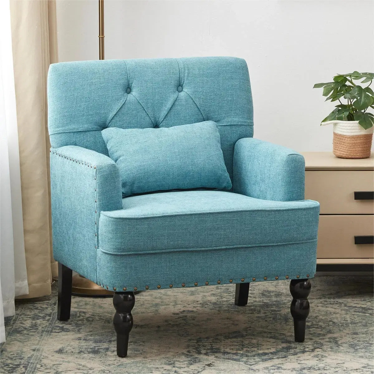 Sky blue upholstered accent chair with tufted back, lumbar pillow and dark turned wood legs