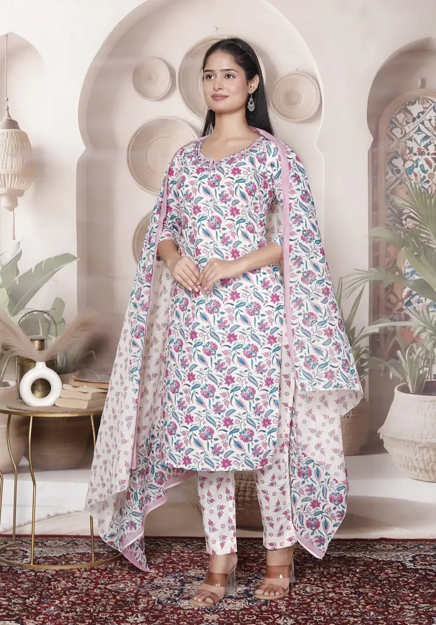 Woman wearing a pastel floral printed kurta set with matching pants and dupatta