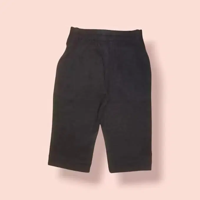 Black kids knee-length shorts with an elastic waistband on a light background