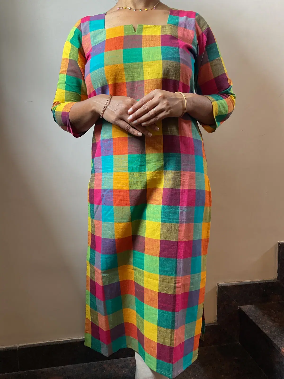 Woman wearing a multicolor checked straight kurta with three-quarter sleeves and square neckline