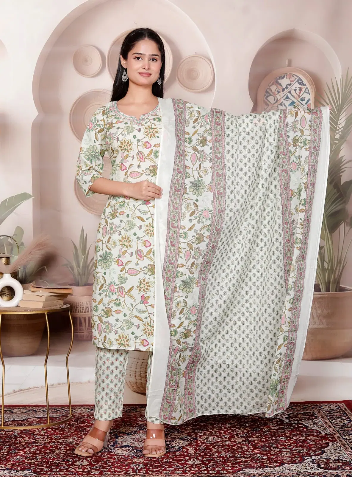 Woman wearing a white floral printed kurta and pants set with matching dupatta
