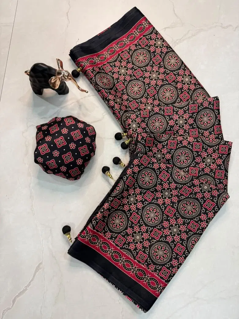 Black and red printed saree fabric set with matching blouse piece and tassel details